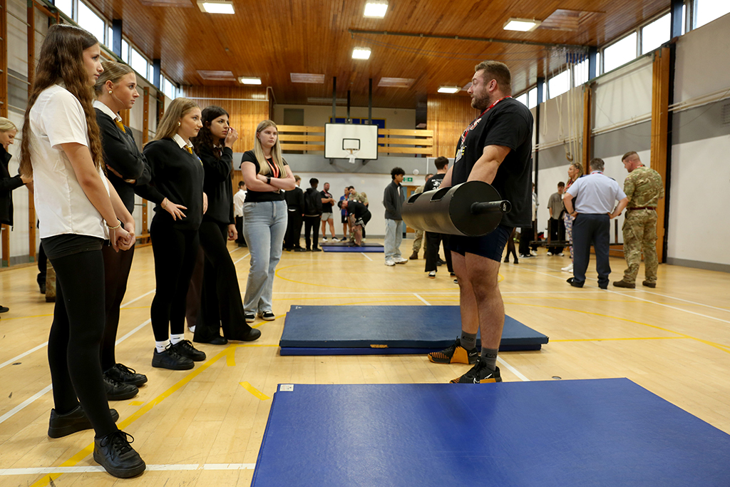 Students at Carterton Community College watching a demonstration of a weight lifting challenges.